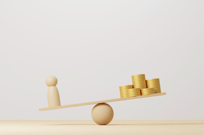 Wooden figure on a seesaw balanced against stacks of gold coins, symbolizing time versus money in business decisions